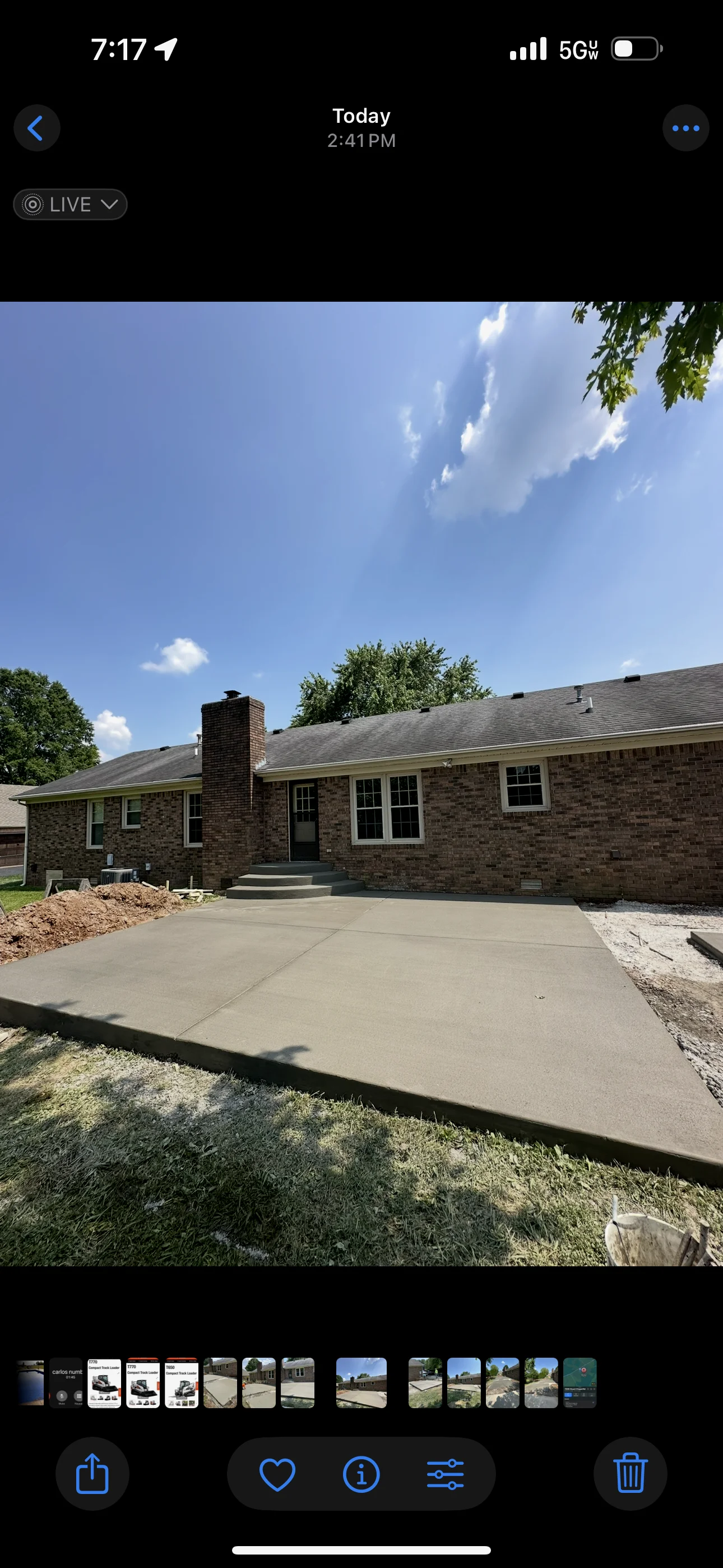 New concrete driveway with fresh sod and landscape grading at brick ranch home